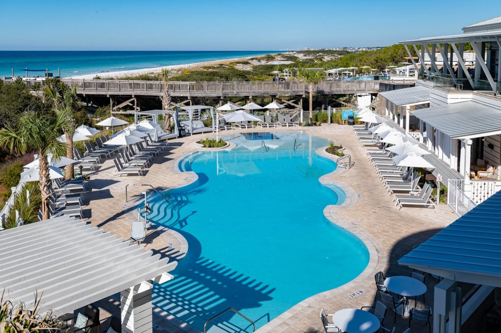 aerial view of a resort pool next to the beach